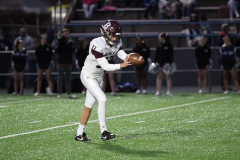 Connor Mollohan punting the ball.